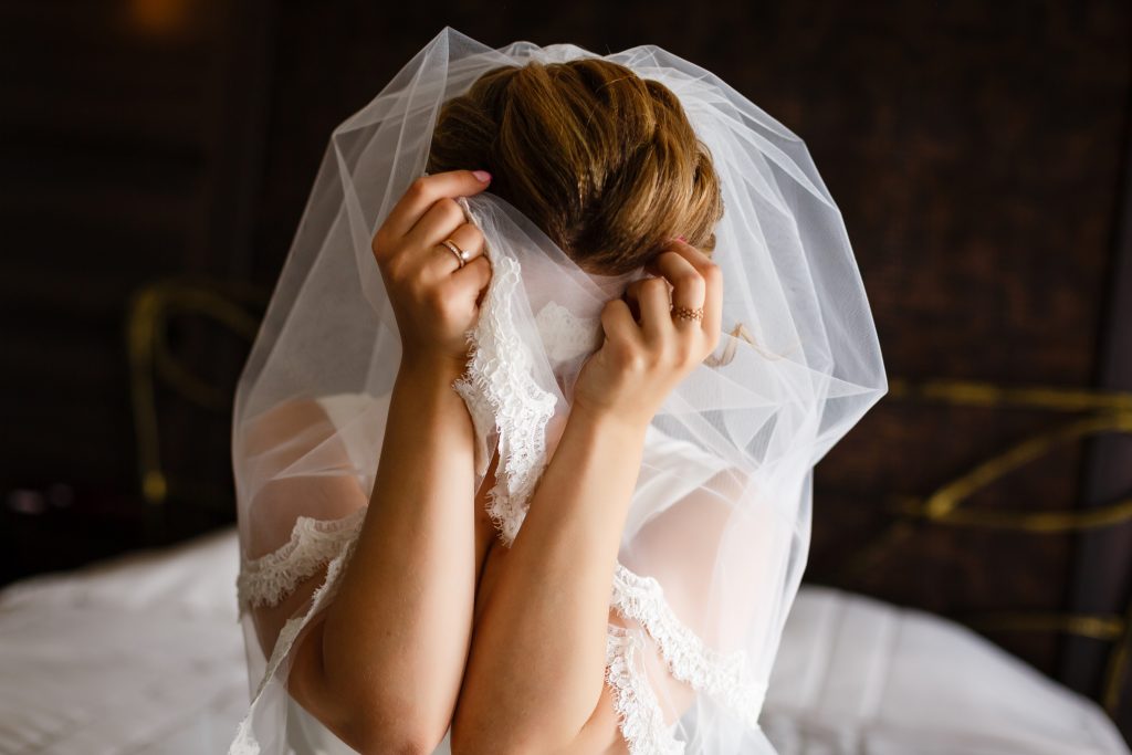 10 things not to forget on your wedding day. The bride covered her face with her hands and veil